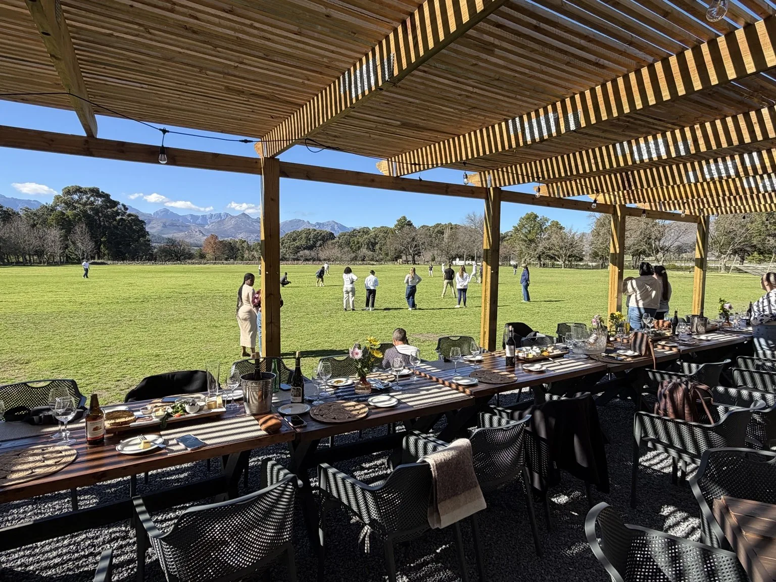 Tables on the covered patio overlooking cricket at Pickstone Oval