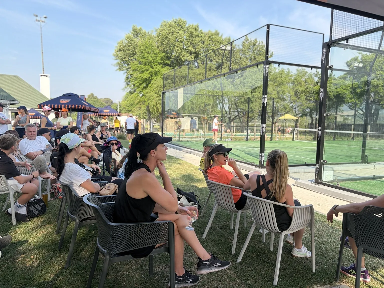 Spectators and players gathering courtside
