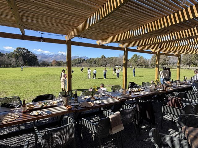 Tables set on the patio overlooking cricket