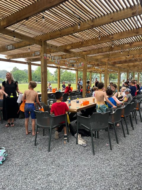 Friends gathering at the outdoor tables